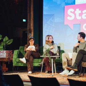 Adult Chair Conversation Couch Female Furniture Glasses Interview Male Man Microphone Person Shoe Woman